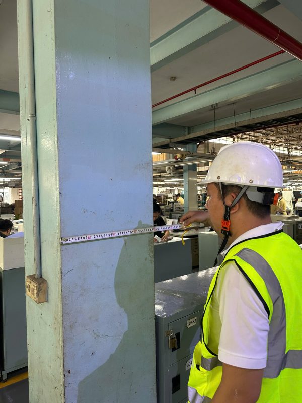 Kỹ sư kiểm định kiểm tra hiện trạng kết cấu cột nhà xưởng trong quá trình đánh giá chất lượng công trình.