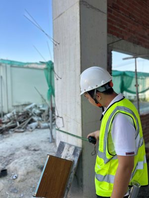 Đo kiểm kích thước cột bê tông trong công tác kiểm định chứng nhận an toàn công trình.